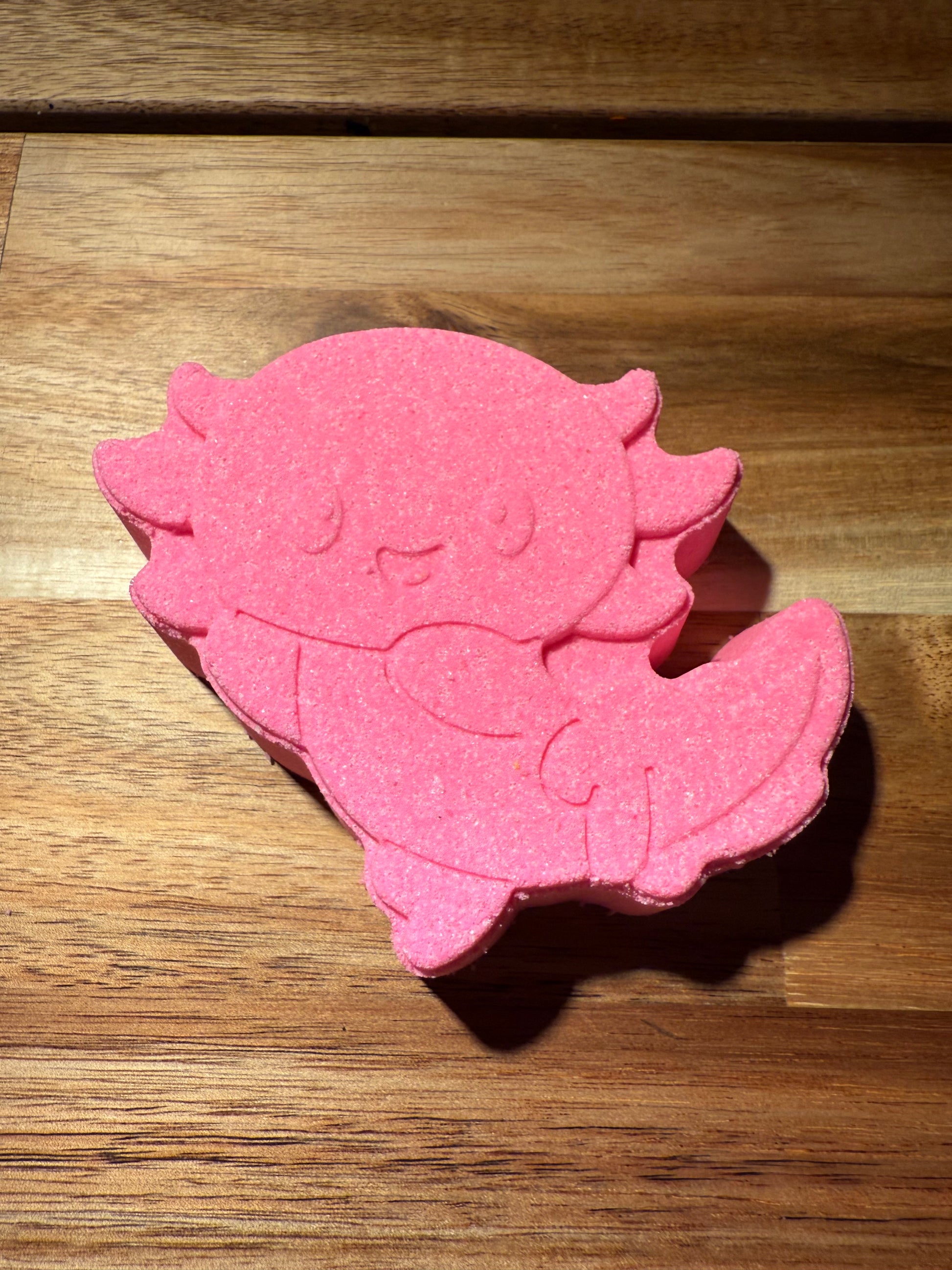 Pink Axolotl on wooden table